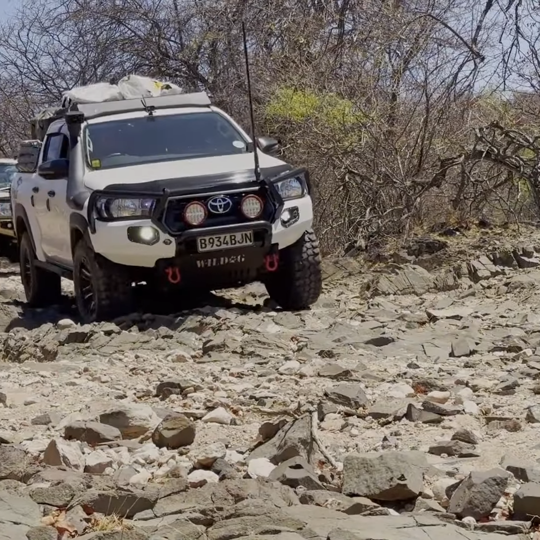 Affordable self-drive safari vehicle on a scenic route, highlighting the adventure and cost-effectiveness of exploring nature independently.